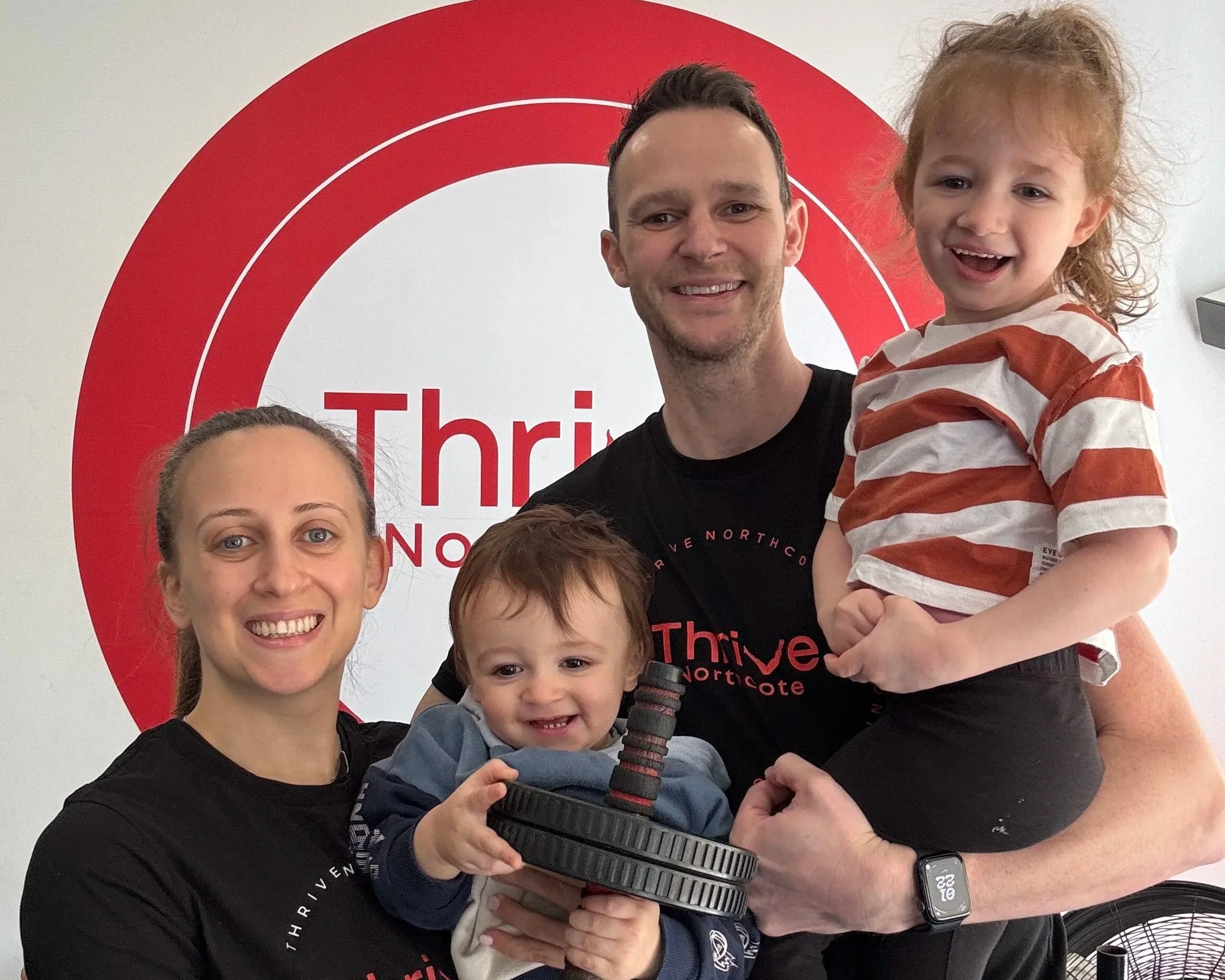 A Thrive Northcote member training while holding their baby in the Northcote studio